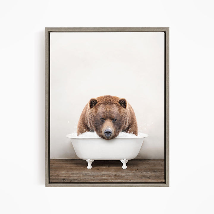 A brown bear sitting in a white bathtub, appearing to be enjoying a relaxing bath.