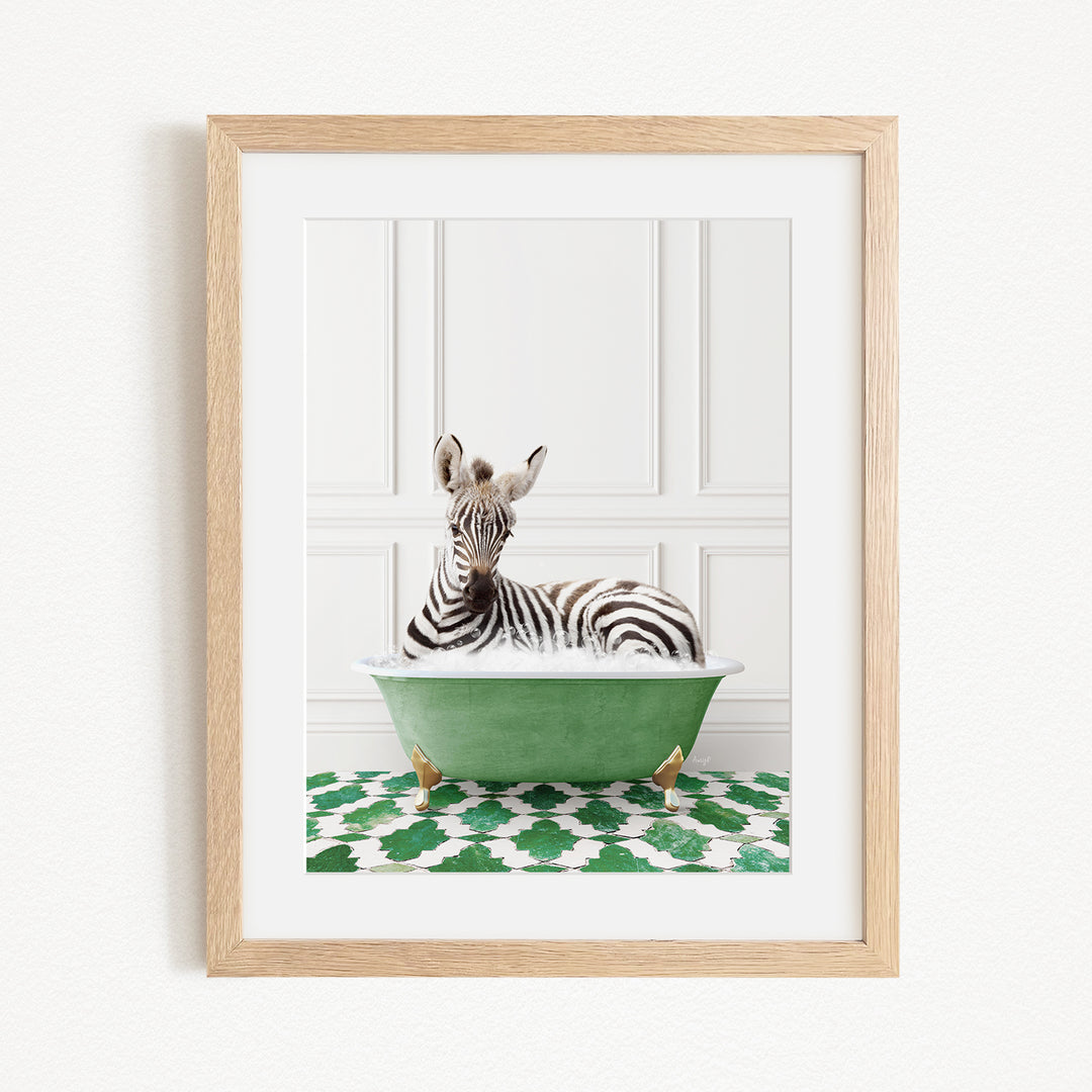 A zebra is sitting in a green bathtub, surrounded by a patterned green and white rug.