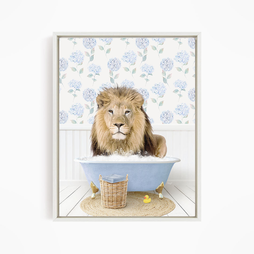 A lion is sitting in a blue bathtub filled with water, surrounded by a wicker basket and a yellow rubber duck.