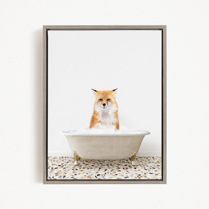 A red fox sitting in a white bathtub filled with water, looking directly at the camera.