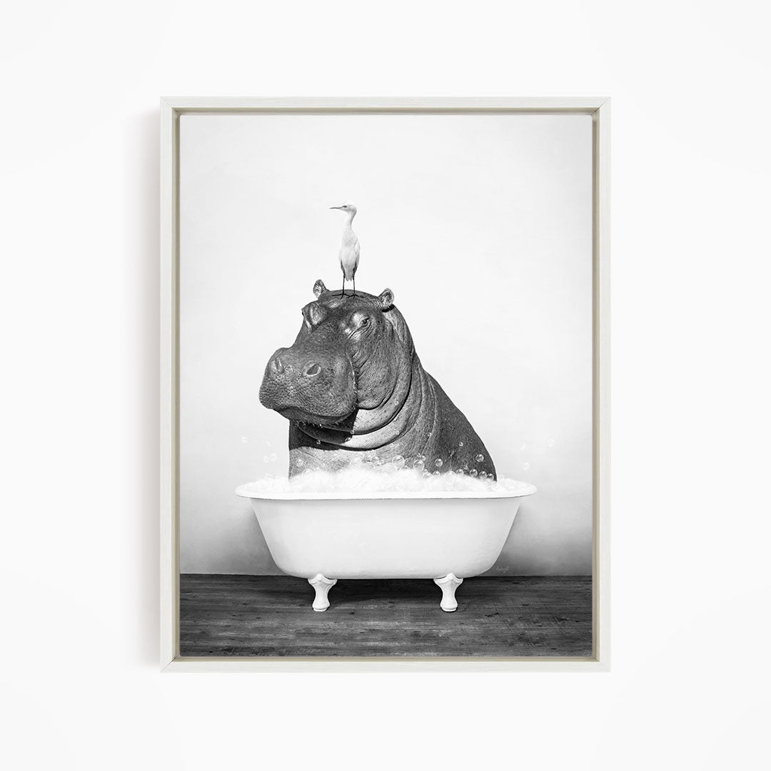 A black and white image depicting a hippopotamus sitting in a bathtub, with a bird perched on its head.