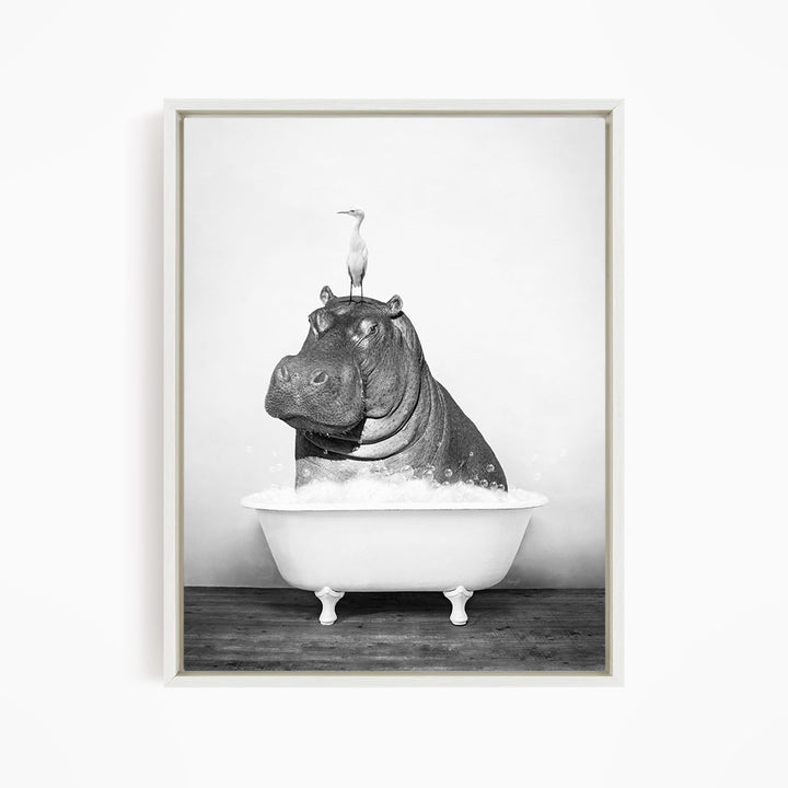 A black and white image depicting a hippopotamus sitting in a bathtub, with a bird perched on its head.