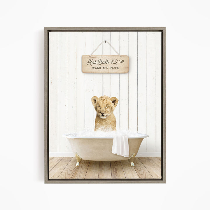 A young lion cub sitting in a bathtub, with a sign above the tub that reads "Hot Bath $2.00 WASH YOUR Paws".