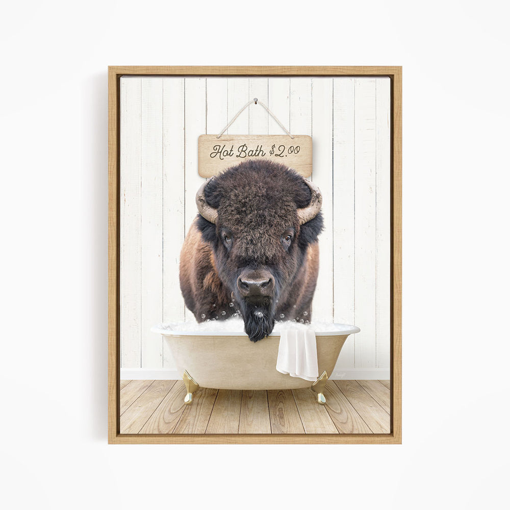 A buffalo with large horns is sitting in a bathtub, with a sign above it that reads "Hot Bath $2.00".