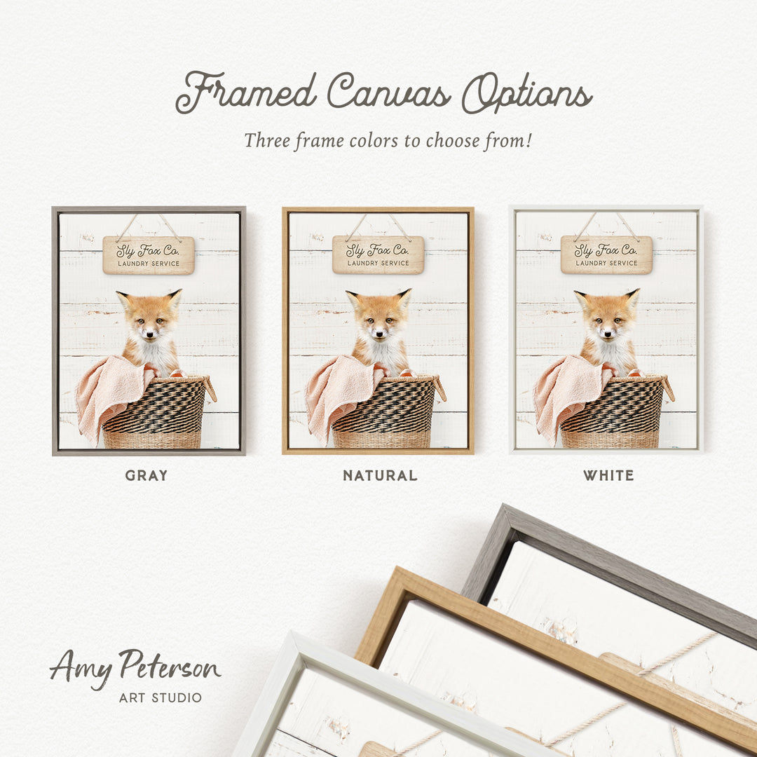 The image is a framed canvas option featuring three different framed pictures of a small orange and white fox sitting in a basket. The options include a gray, a natural, and a white frame.