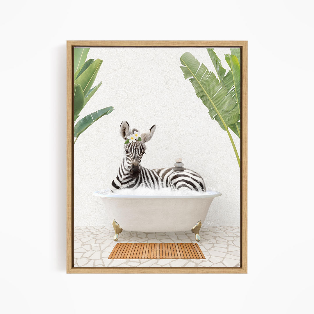 A zebra is sitting in a white bathtub, surrounded by tropical plants and a wooden mat on the floor.