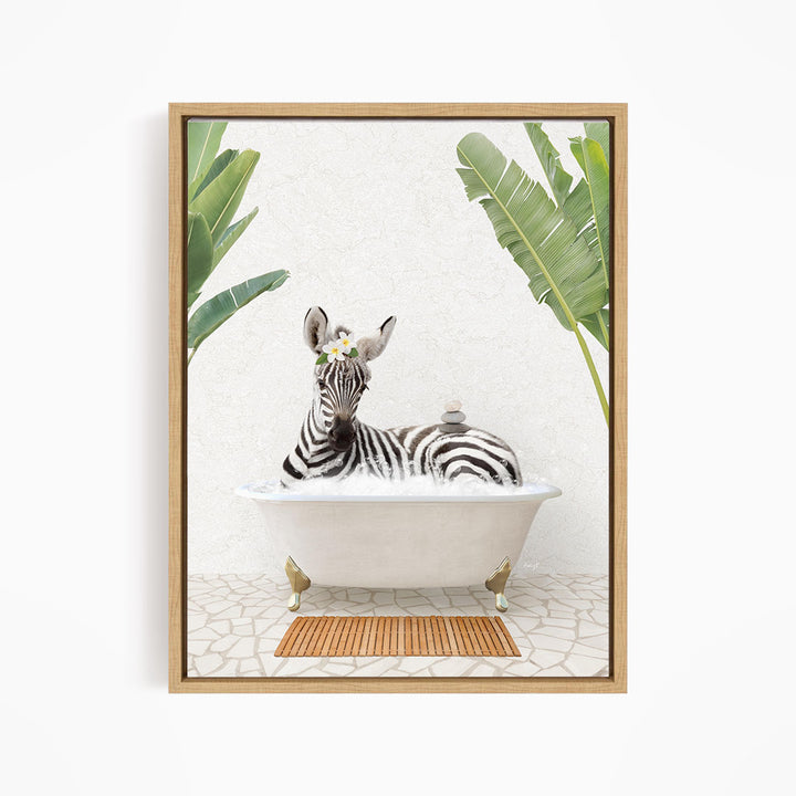 A zebra is sitting in a white bathtub, surrounded by tropical plants and a wooden mat on the floor.