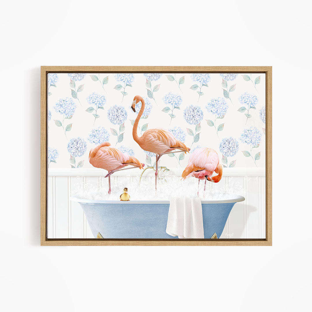 A framed image depicting three flamingos standing in a bathtub filled with water, surrounded by a floral pattern.