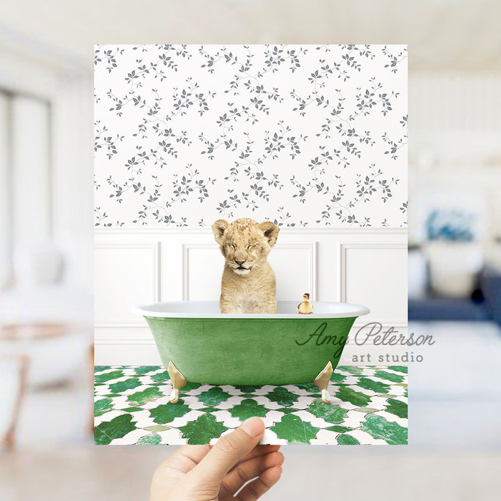 a hand holding a card with a picture of a baby lion in a bathtub