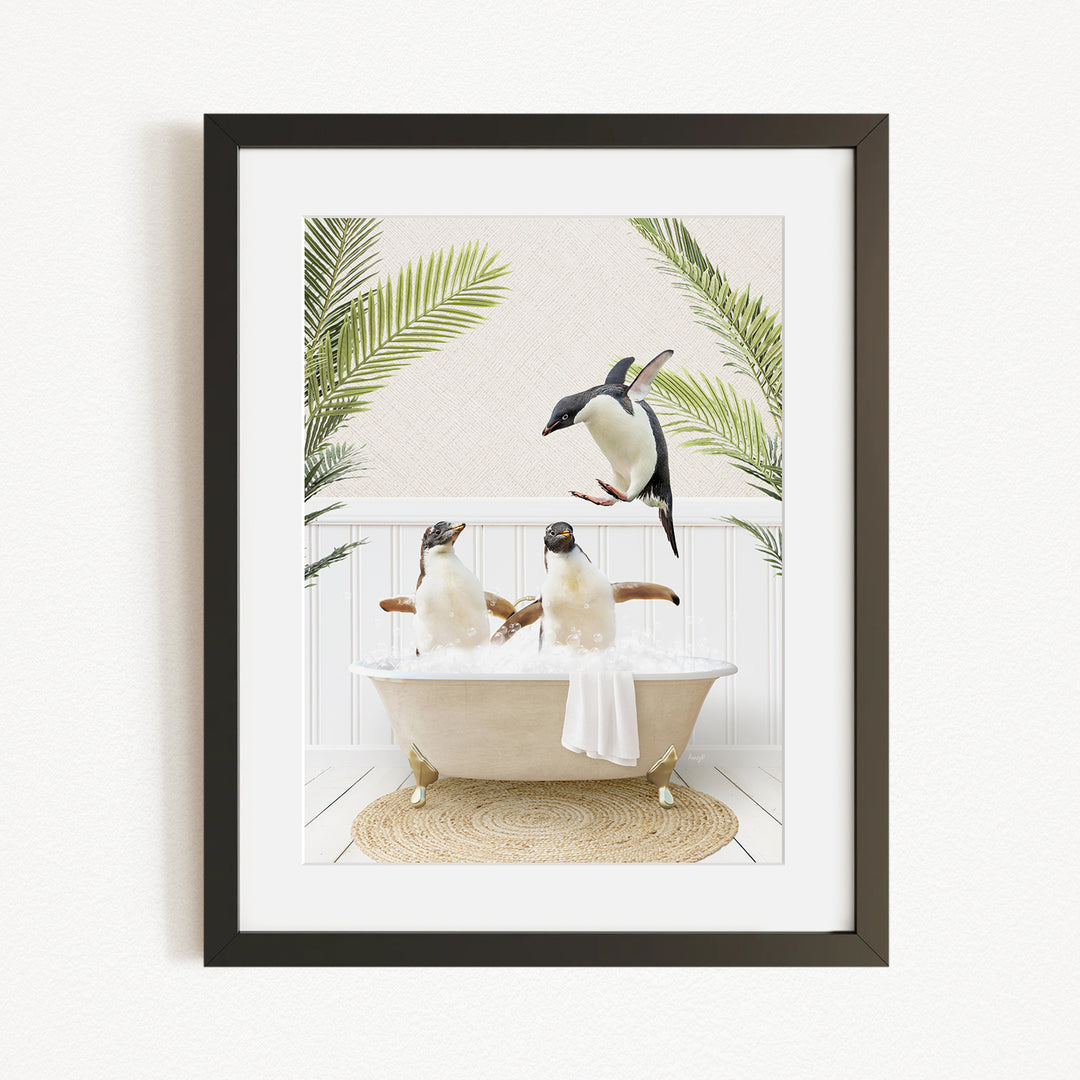 A framed image depicting two penguins sitting in a bathtub, surrounded by palm leaves, creating a whimsical and playful scene.