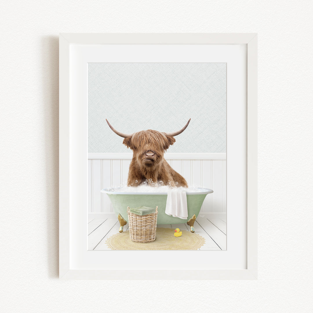 A Highland cow with long horns is sitting in a green bathtub, surrounded by rubber ducks and a basket.