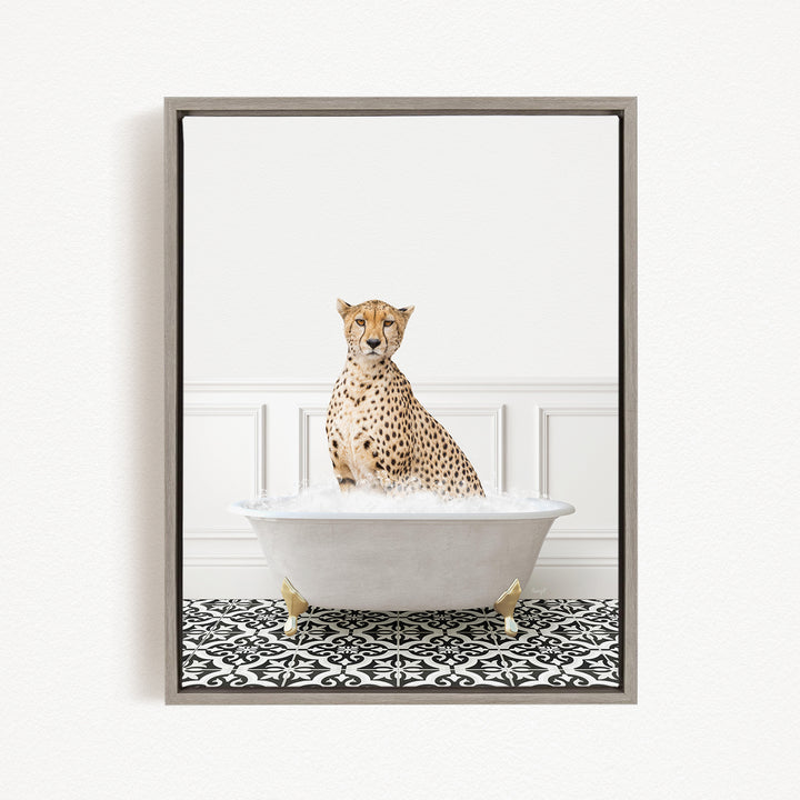 A cheetah sitting in a white bathtub filled with bubbles, looking directly at the camera.