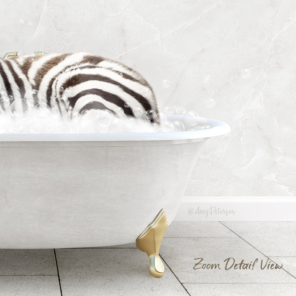 A zebra lying in a white bathtub filled with bubbles, with a gold claw visible on the side of the tub.
