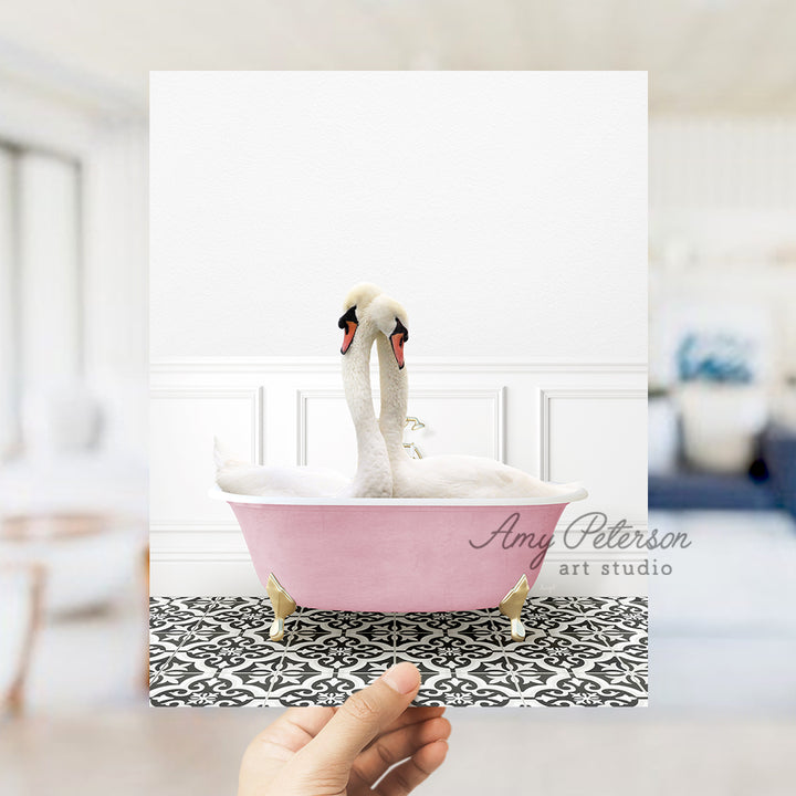 a person holding up a picture of a swan in a bathtub