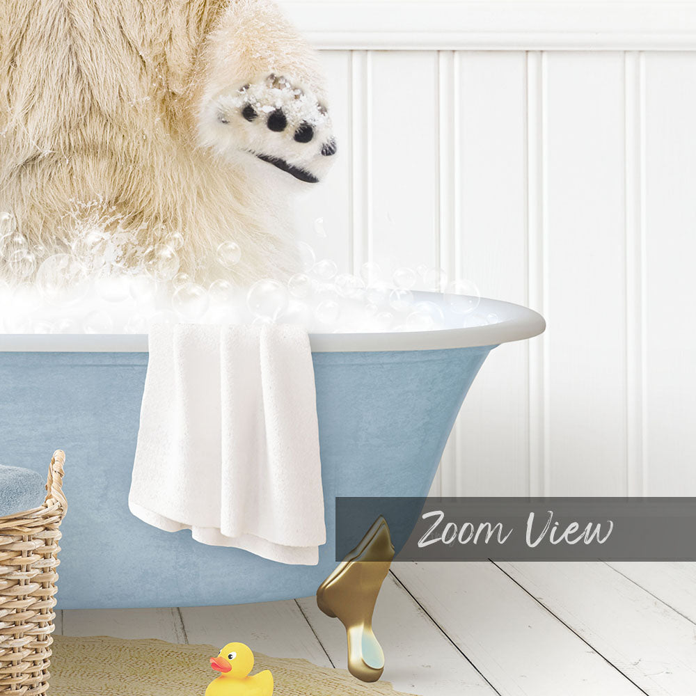 A fluffy white dog is standing in a blue bathtub filled with bubbles, with a yellow rubber duck nearby.