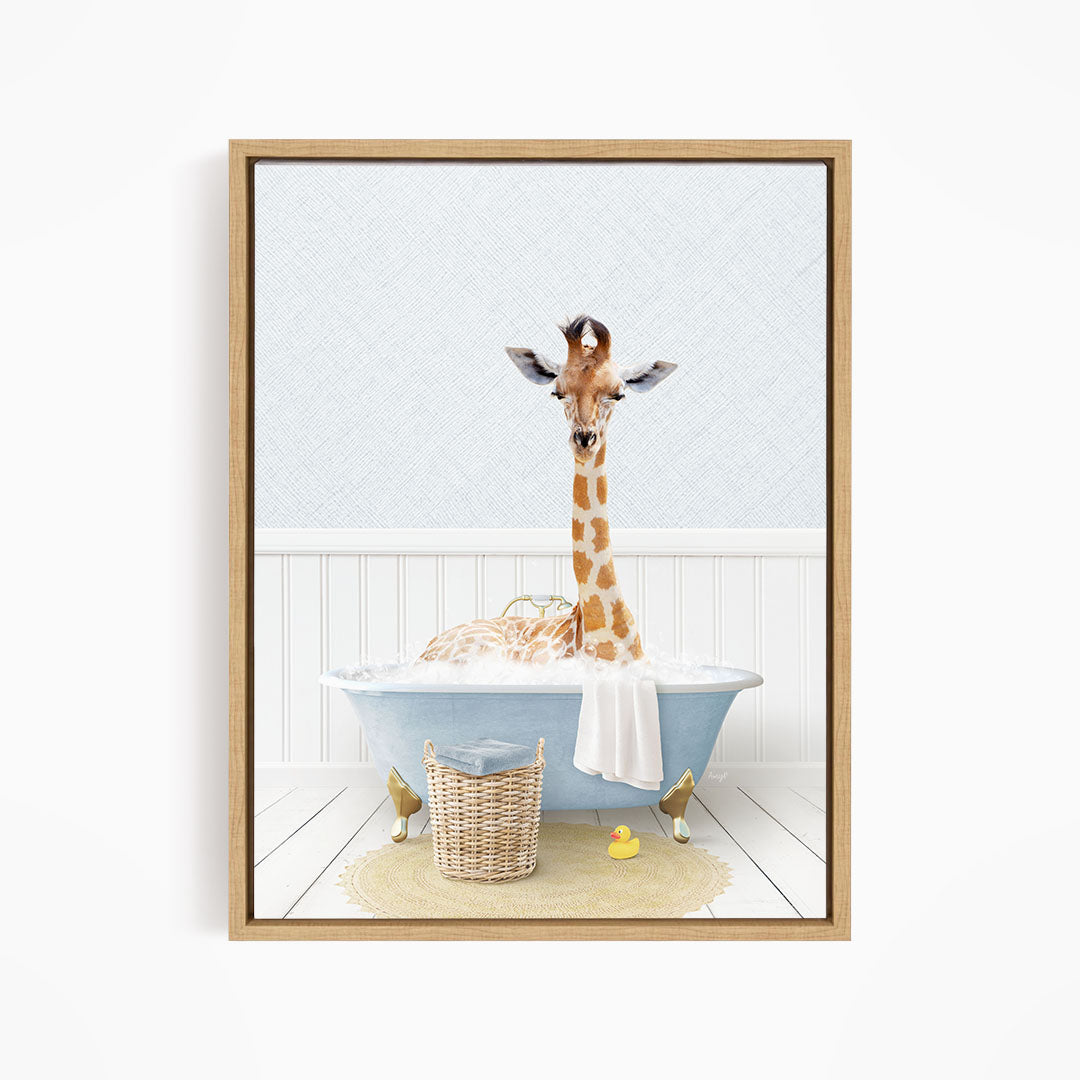 A giraffe is sitting in a blue bathtub filled with water, surrounded by a basket of toys and a yellow rubber duck.