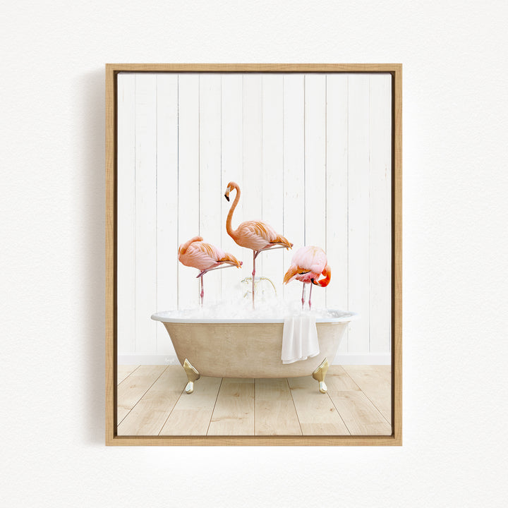 A framed image depicting three flamingos sitting in a bathtub filled with water.