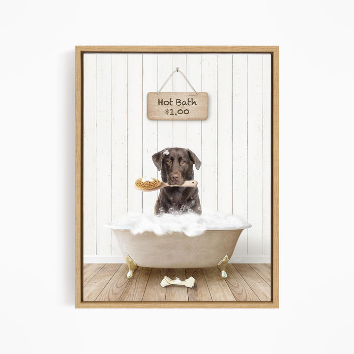 A brown dog is sitting in a white bathtub filled with bubbles, holding a wooden brush in its mouth.