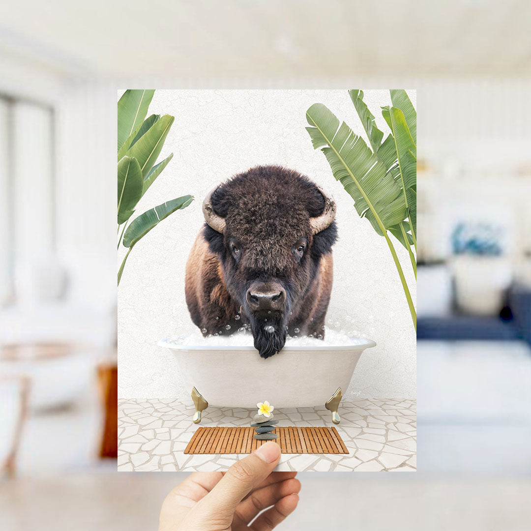A buffalo is sitting in a bathtub filled with water, surrounded by tropical plants.