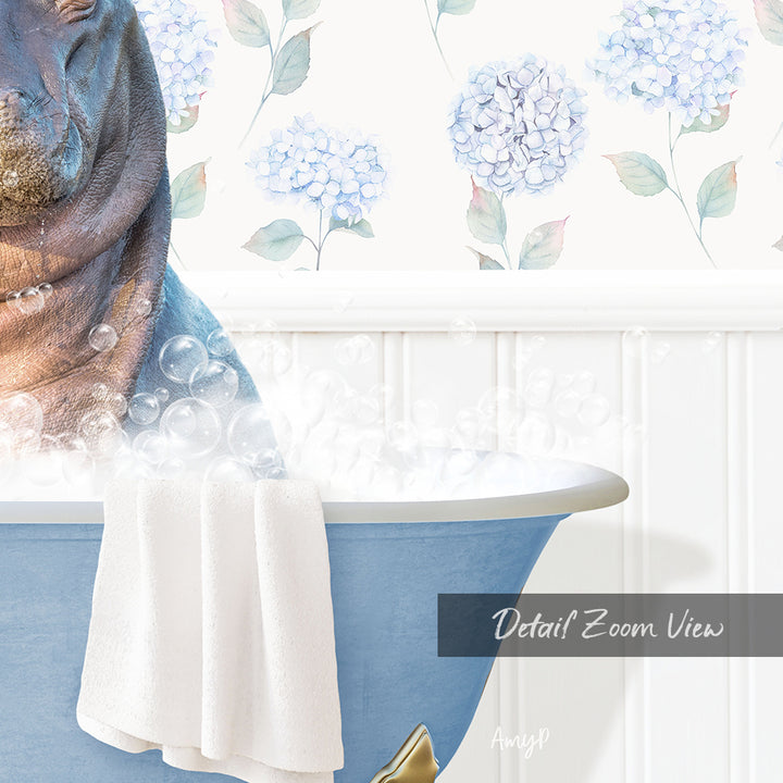 A close-up of a bathtub filled with bubbles, with a towel draped over the side and a floral pattern on the wall behind it.