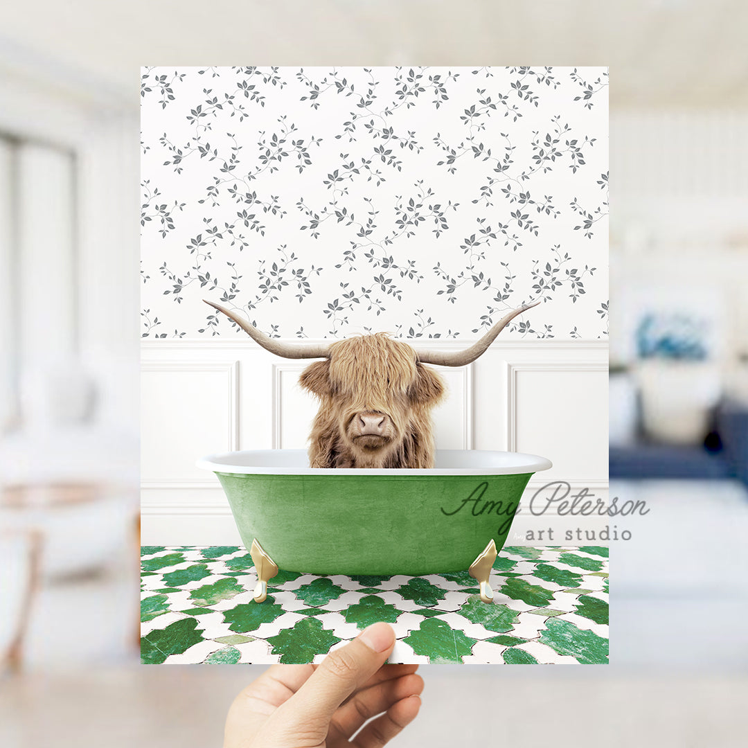 a hand holding up a card with a picture of a cow in a bathtub