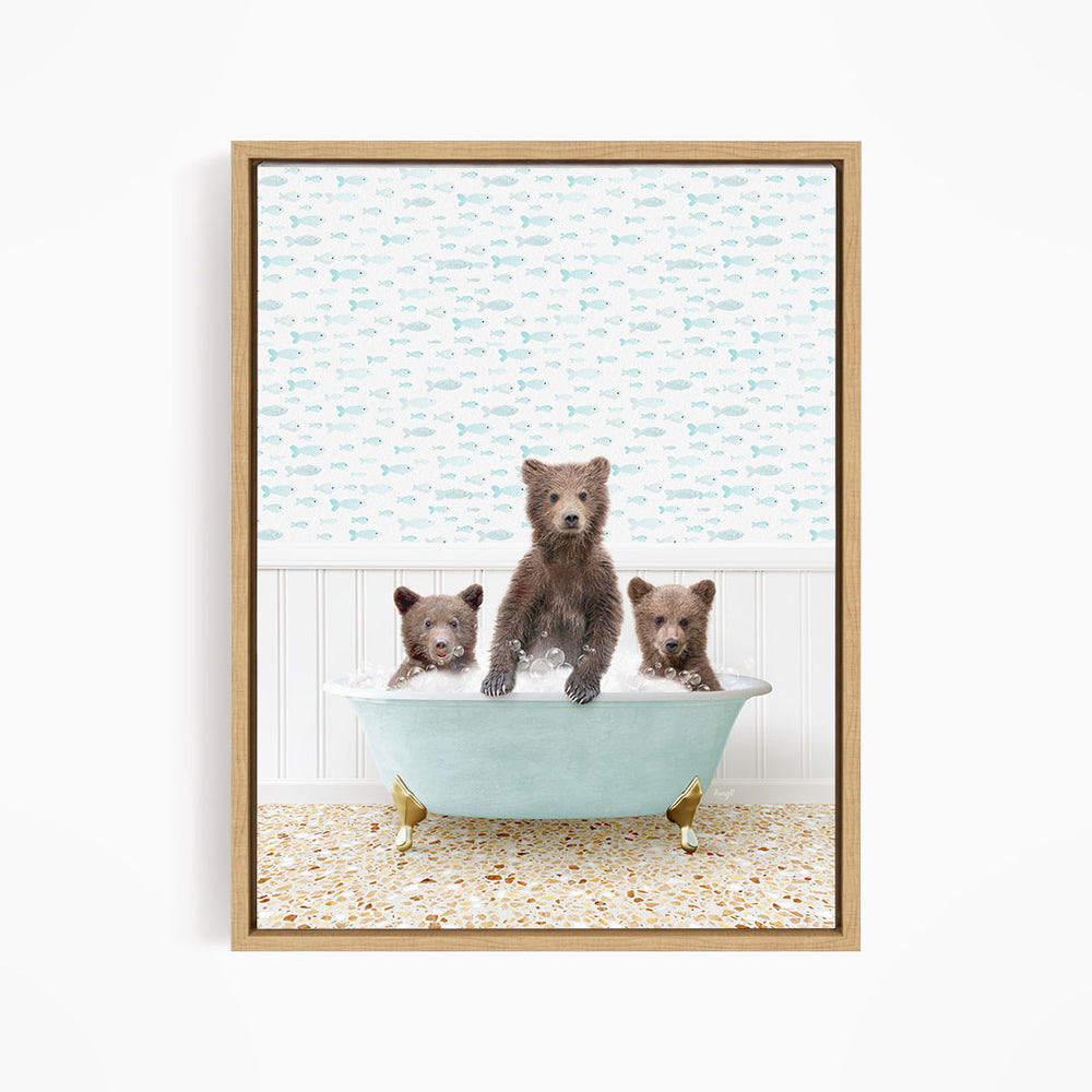 A framed image depicting three bears sitting in a bathtub filled with water, with a patterned wall behind them.