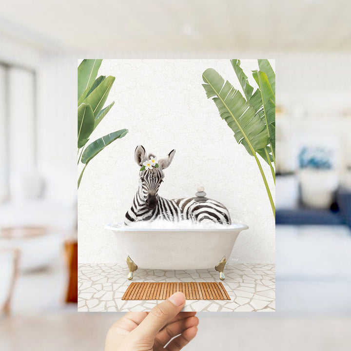 A zebra is sitting in a bathtub filled with water, surrounded by tropical plants.