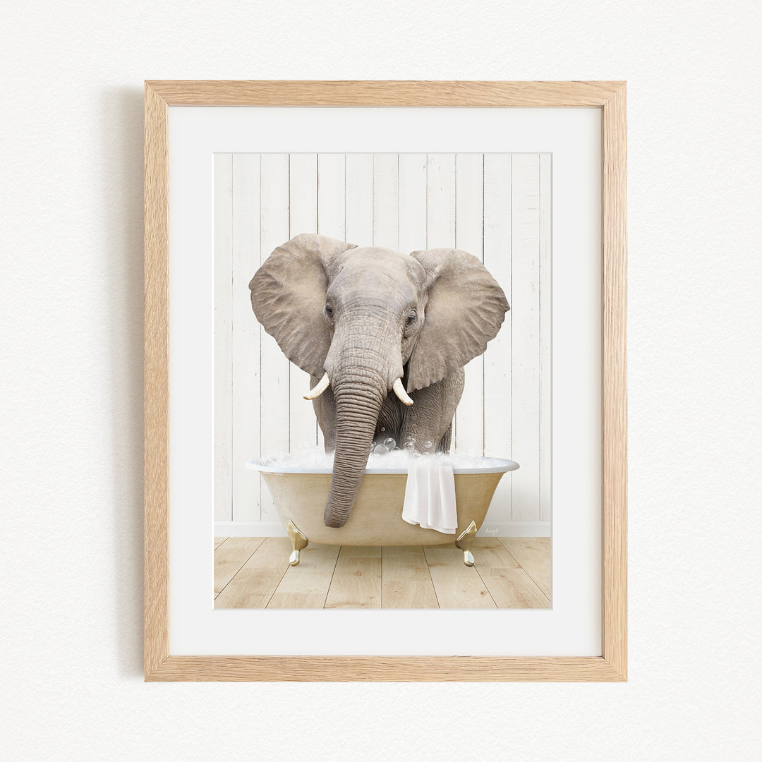 A gray elephant is sitting in a white bathtub, with its trunk extended towards the water.