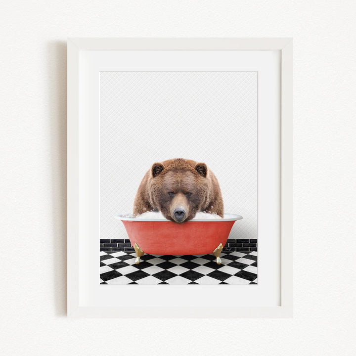 A brown bear is sitting in a red bathtub filled with water, surrounded by a black and white checkered floor.