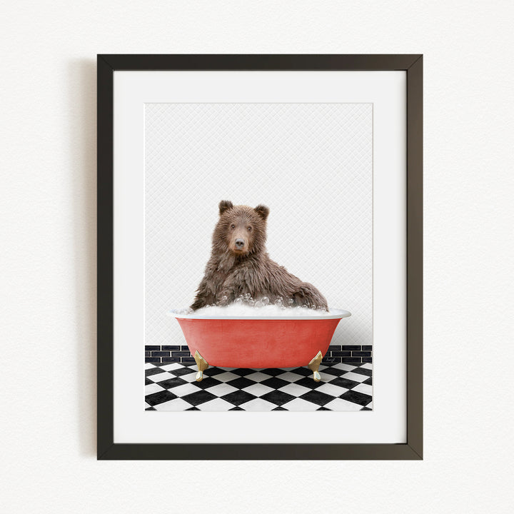 A brown bear sitting in a red bathtub filled with water, surrounded by a black and white checkered floor.