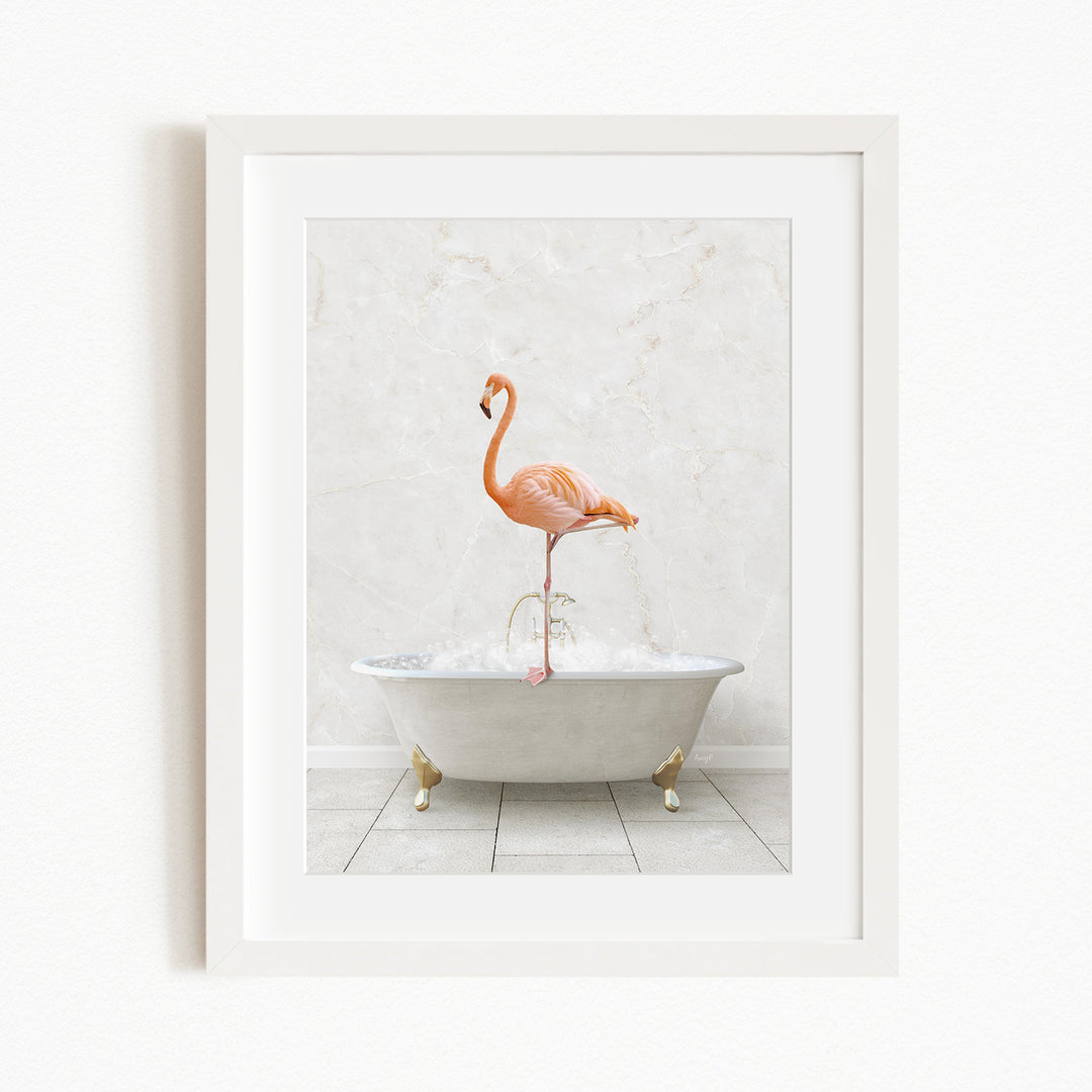 A framed image of a flamingo standing on the edge of a white bathtub filled with water.