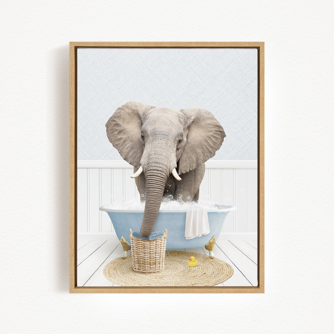 A gray elephant is standing in a blue bathtub filled with water, surrounded by a basket of toys and a yellow rubber duck.