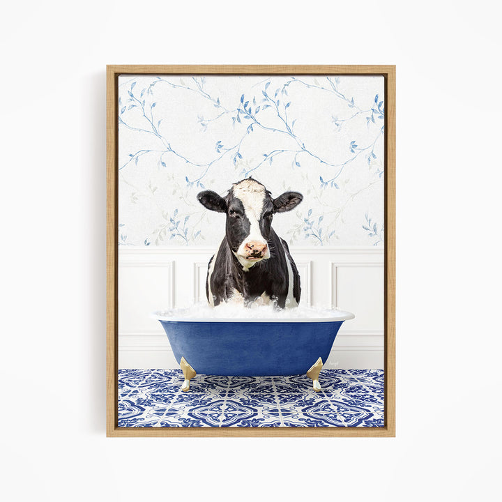 A black and white cow is sitting in a blue bathtub filled with water, surrounded by a blue and white patterned floor.