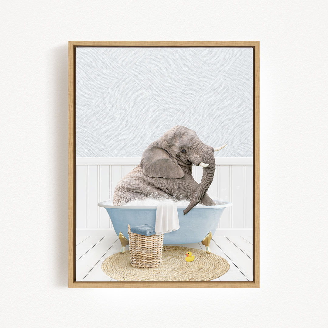 A gray elephant is sitting in a blue bathtub filled with water, surrounded by a basket of toys and a yellow rubber duck.