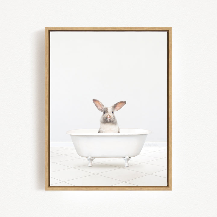 A white rabbit sitting in a white bathtub against a white background.