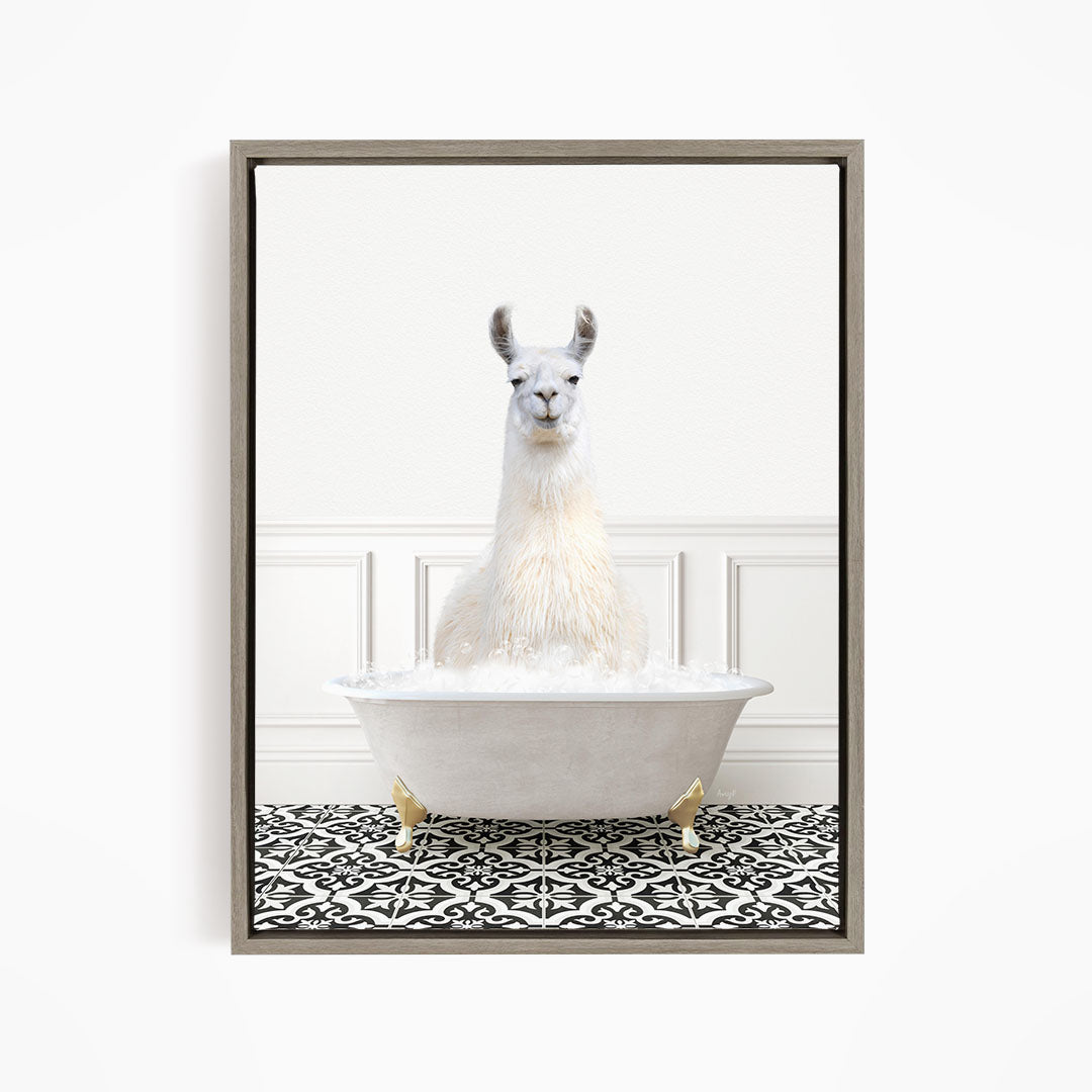 A white llama sitting in a white bathtub filled with bubbles, surrounded by a black and white patterned floor.