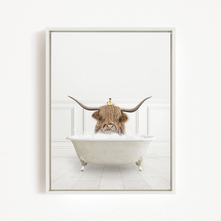 A Highland cow with large horns is sitting in a white bathtub filled with water, with a yellow duck perched on its head.