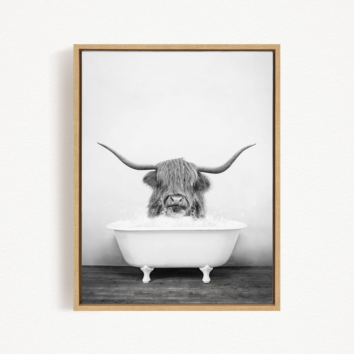 A black and white photograph of a long-haired animal, possibly a yak or a similar species, sitting in a white bathtub and enjoying a bath.