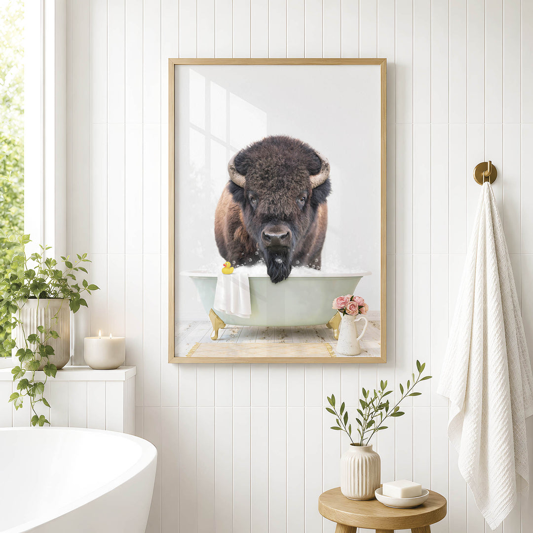 a framed photograph of a buffalo bathing in a tub, surrounded by various decorative elements such as plants, candles, and a vase.