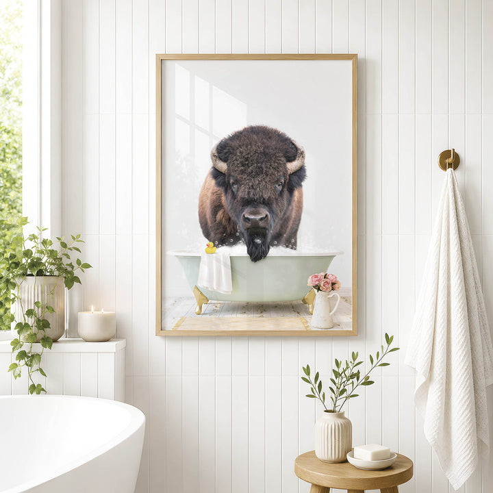 a framed photograph of a buffalo bathing in a tub, surrounded by various decorative elements such as plants, candles, and a vase.