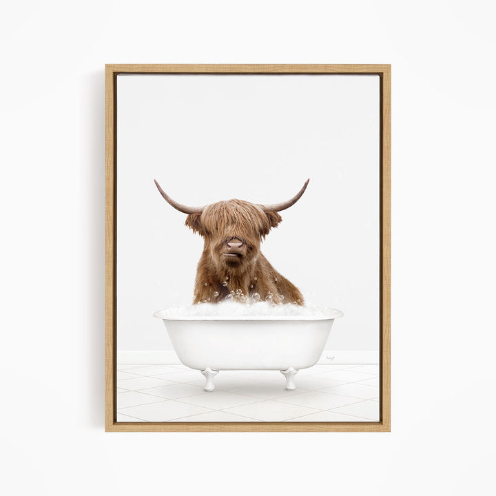A brown cow with long horns is sitting in a white bathtub filled with water, appearing to enjoy the bath.