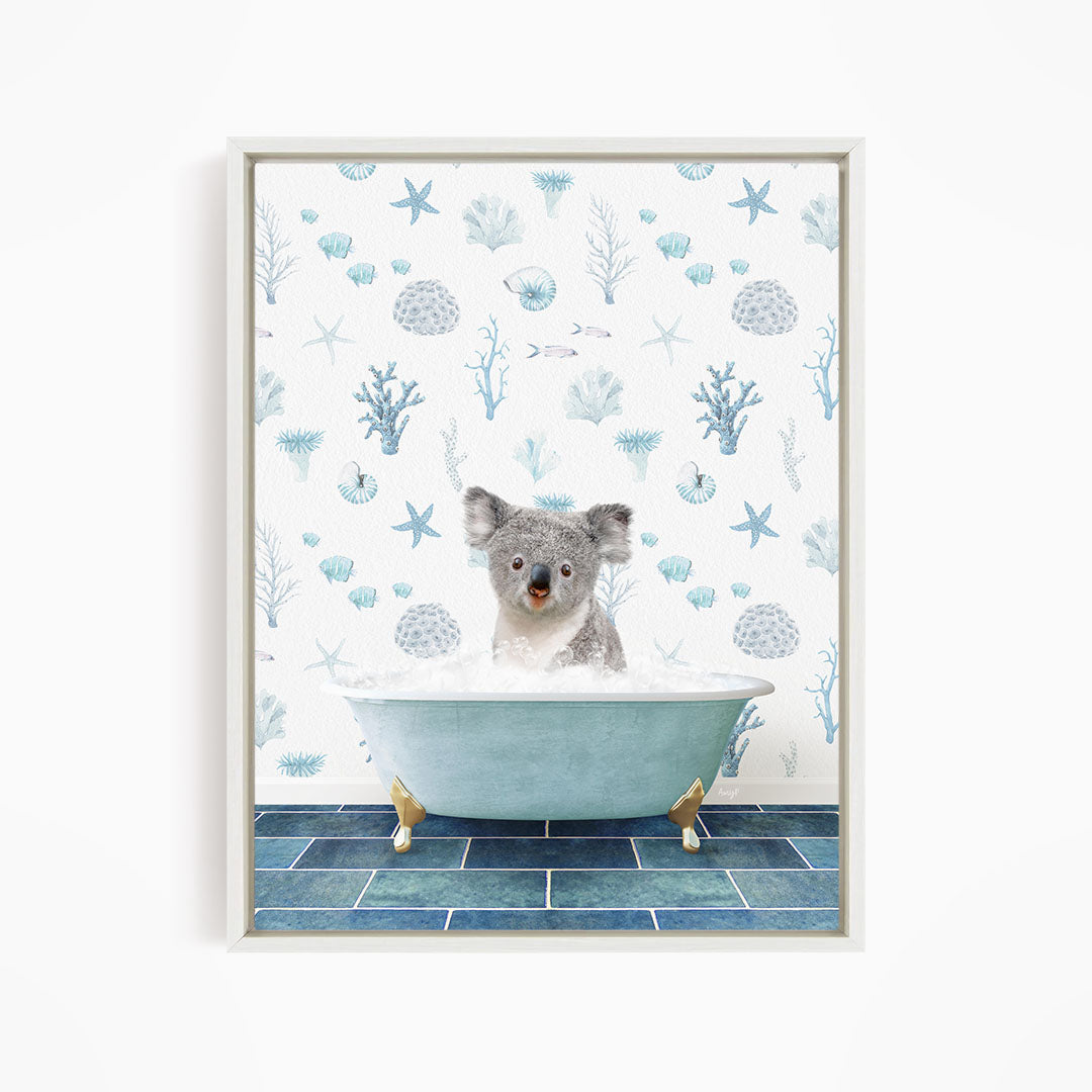 A koala bear sitting in a blue bathtub filled with bubbles, surrounded by a pattern of blue and white marine life.