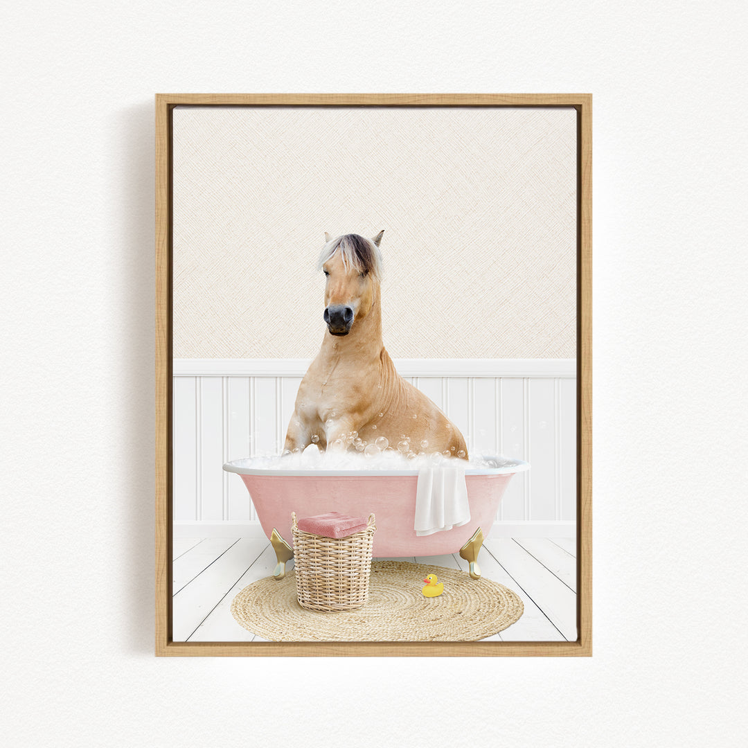 A brown horse sitting in a pink bathtub filled with bubbles, surrounded by a basket of toys and a yellow rubber duck.