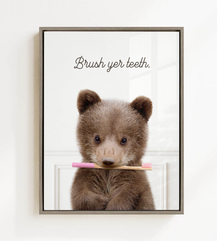 A cute brown bear holding a pink toothbrush in its mouth, with the text "Brush yer teeth" above it.