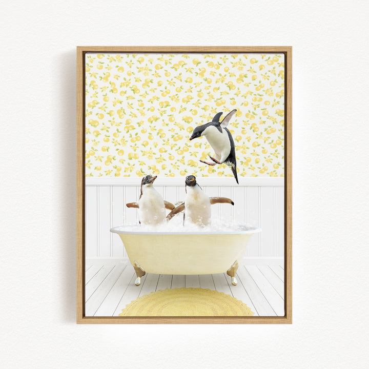 A framed image depicting three penguins sitting in a bathtub, with one penguin jumping out of the tub.