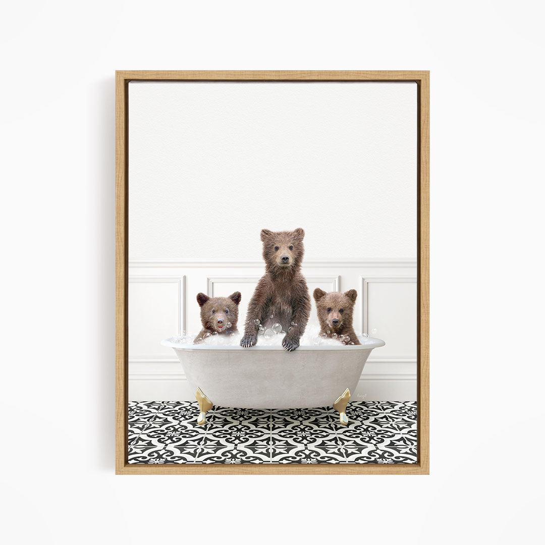 A framed image showing three bears sitting in a white bathtub, with one bear sitting in the center and the other two bears sitting on either side.