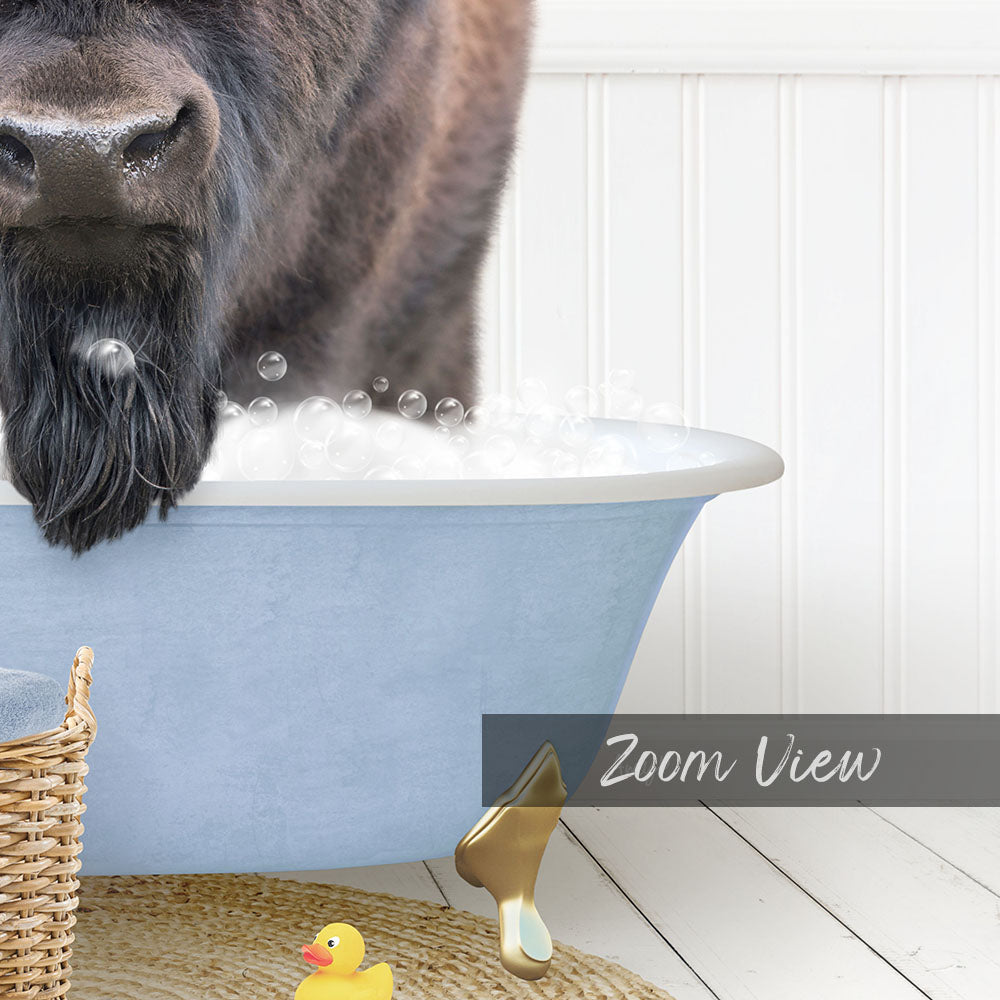 A dog with a long beard is standing in a blue bathtub filled with bubbles, with a yellow rubber duck nearby.