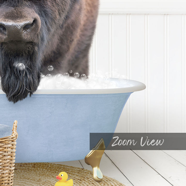 A dog with a long beard is standing in a blue bathtub filled with bubbles, with a yellow rubber duck nearby.