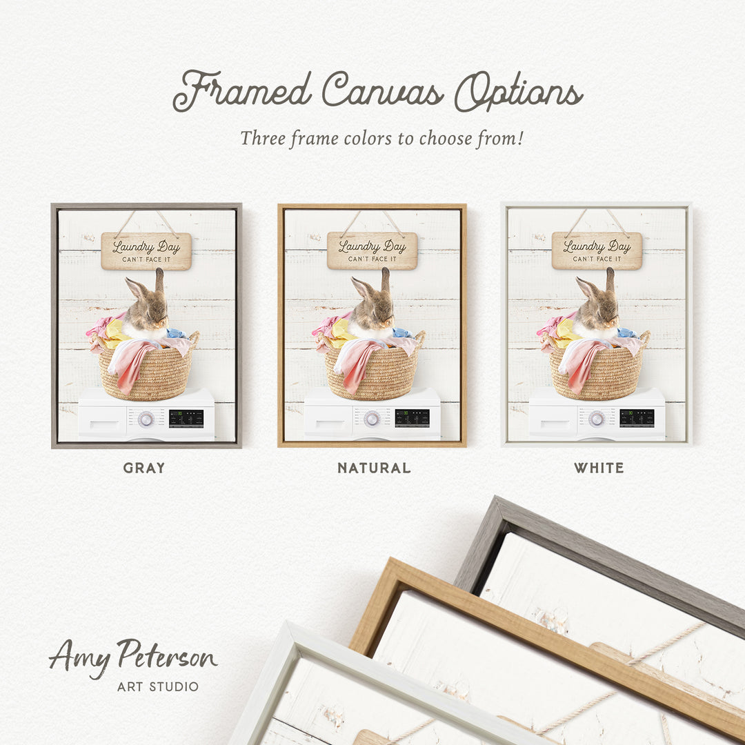 The image is a framed canvas option featuring a laundry basket with a rabbit inside, accompanied by three different frame colors: gray, natural, and white.
