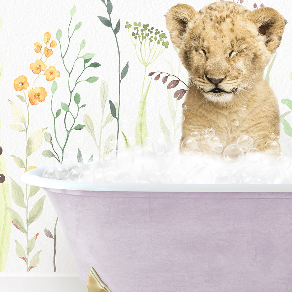 a lion cub sitting in a bathtub filled with bubbles